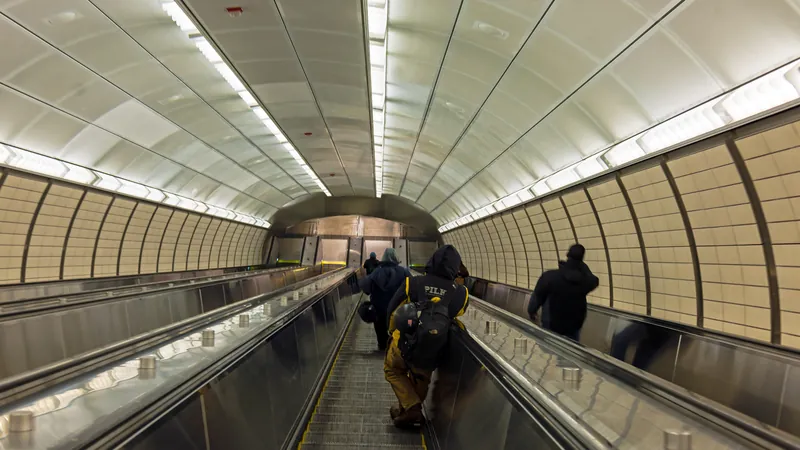 Riders on the long escalators between the mezzanine and lobby of the 34th Street–Hudson Yards subway station.